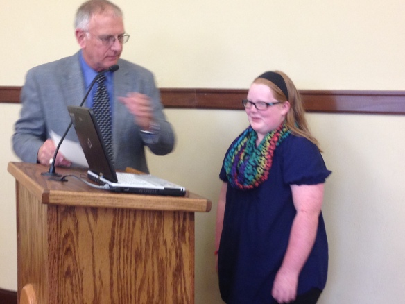 Kamrie and Mayor Eaton as he reads the proclamation before the city council